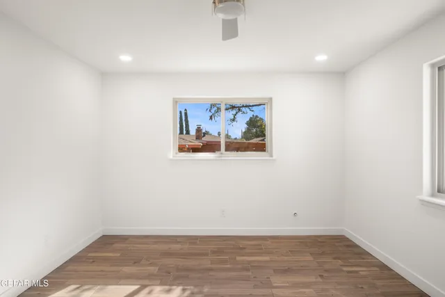 an empty room with windows and closet