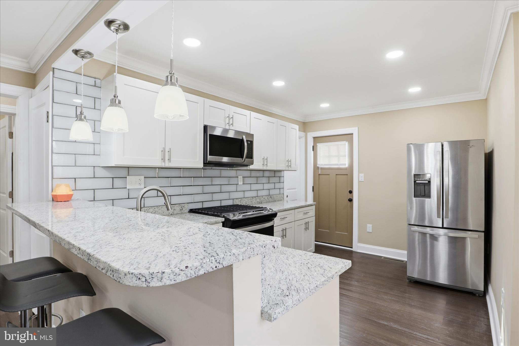a kitchen with granite countertop a sink appliances and cabinets