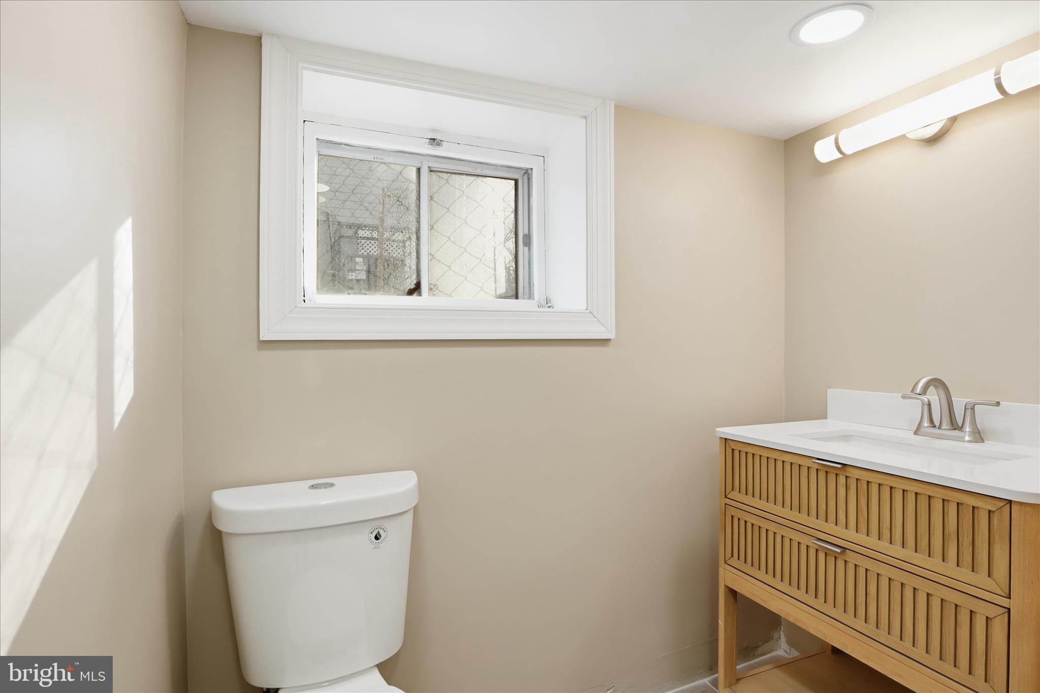 3801 West Overlea Avenue Baltimore, MD 21206 - Photo 14 of 29 a bathroom with a toilet sink and mirror