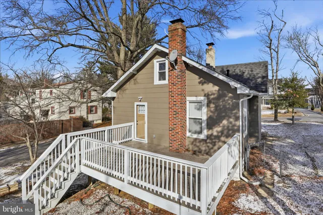 a view of a house with a wooden deck