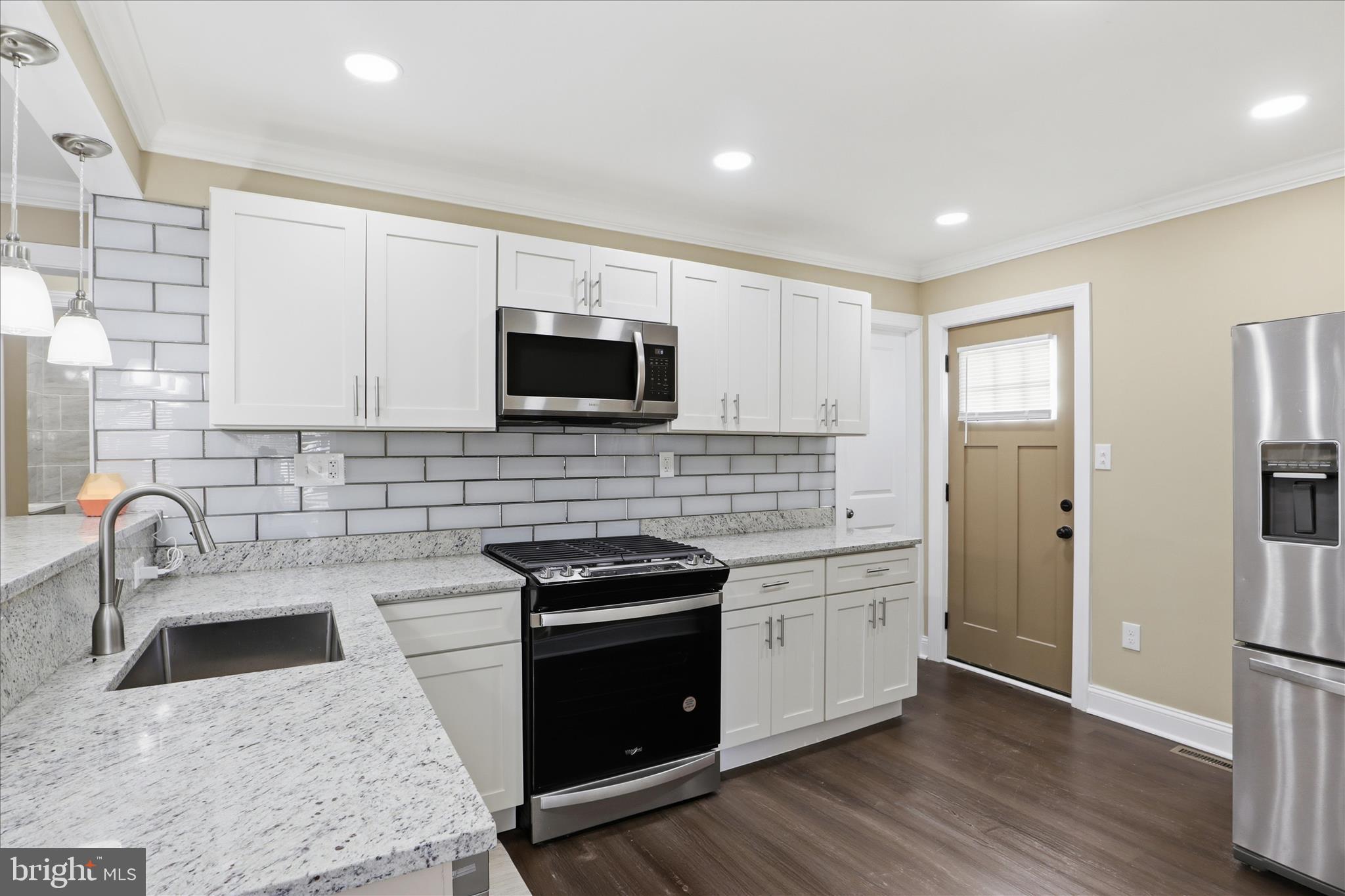 3801 West Overlea Avenue Baltimore, MD 21206 - Photo 2 of 29 a kitchen with stainless steel appliances granite countertop a stove a sink and a microwave