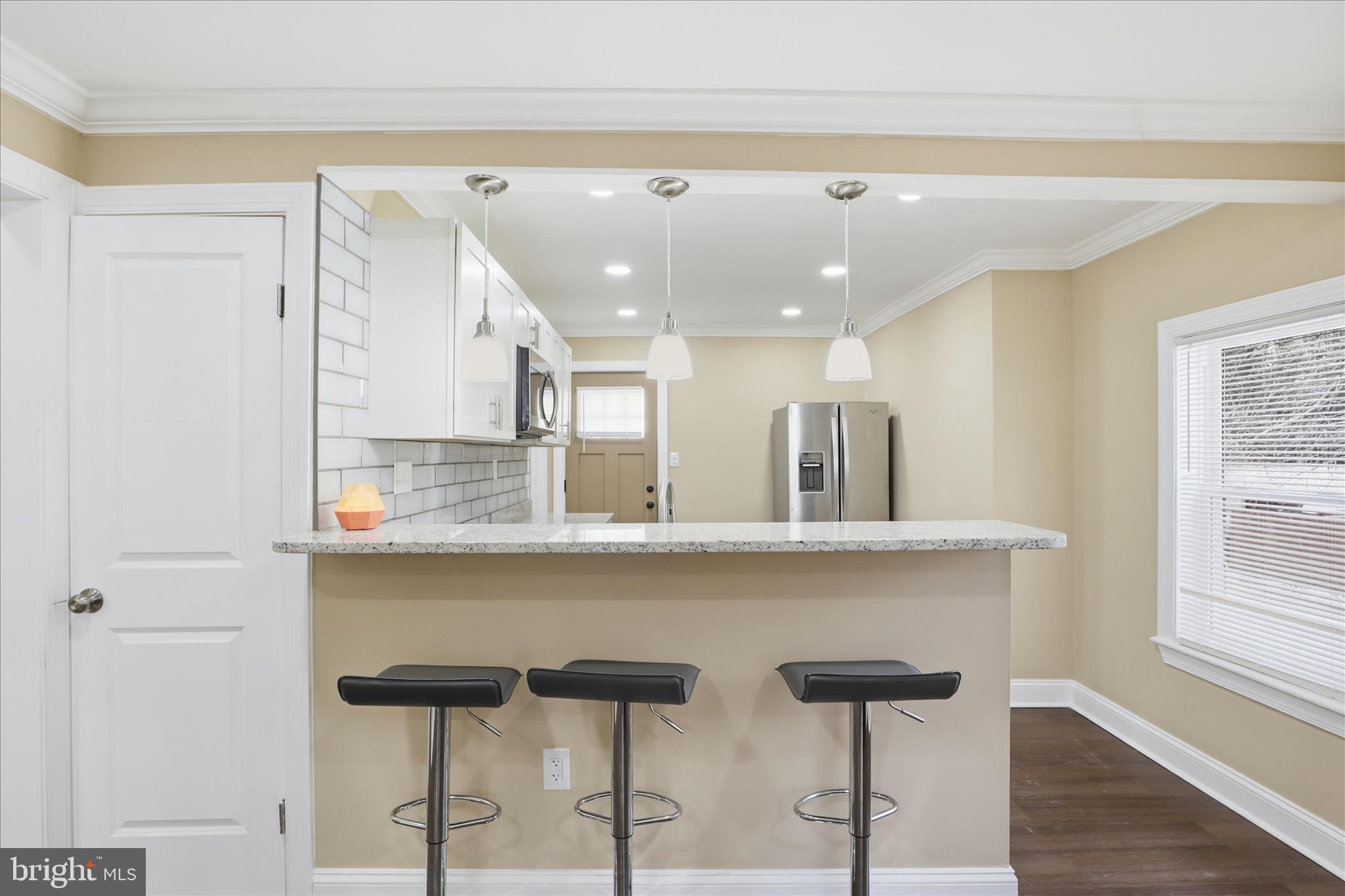 3801 West Overlea Avenue Baltimore, MD 21206 - Photo 3 of 29 a kitchen with a table and chairs in it