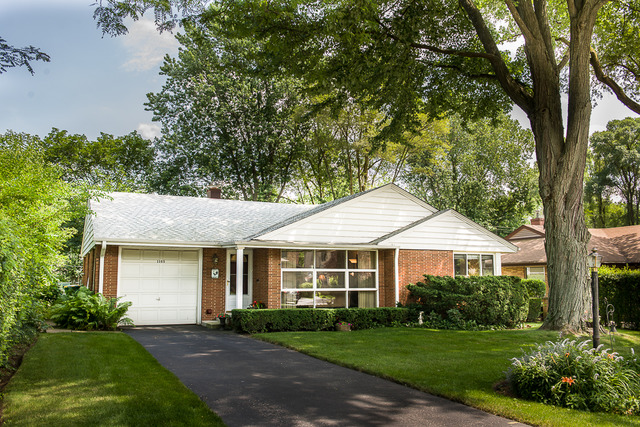 1165 Oxford Road Deerfield, IL 60015 - Photo 1 of 16 a front view of a house with a yard and trees