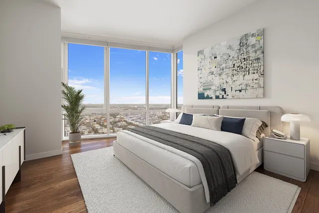 a spacious bedroom with a bed and a couch