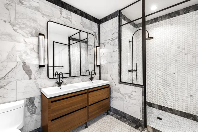 a bathroom with a shower sink and mirror