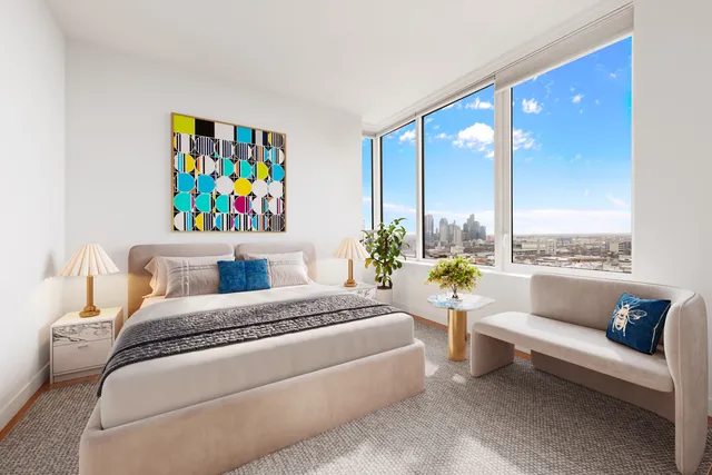 a bedroom with furniture and a painting on the wall