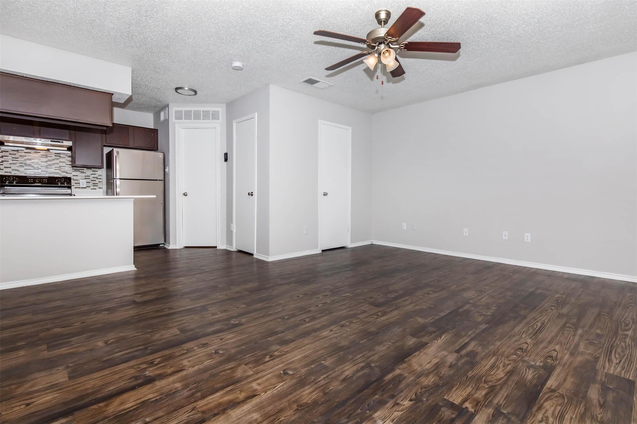 8301 Boat Club Road, Unit 811 Fort Worth, TX 76179 - Photo 2 of 36 a view of a kitchen with wooden floor and a ceiling fan