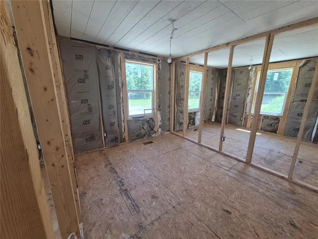a spacious bathroom with a glass shower door and a sink