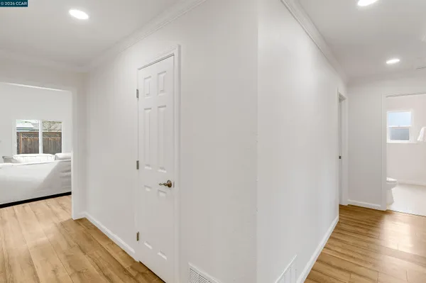 a view of a room with wooden floor and white walls