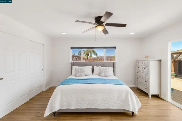 a bedroom with a large bed and a chandelier