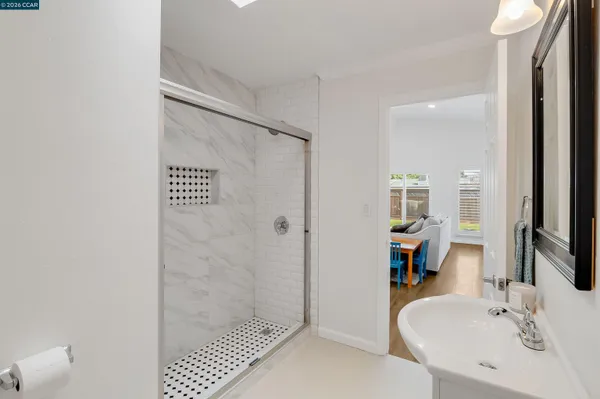 a bathroom with a sink a toilet and shower