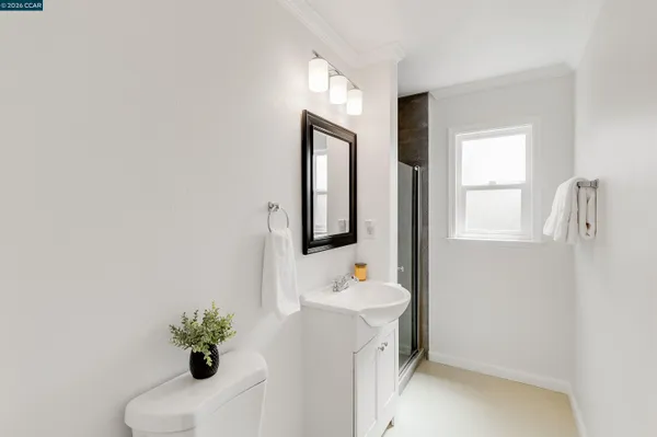 a bathroom with a sink toilet and mirror