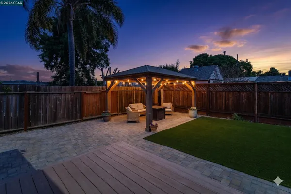 a view of a backyard with sitting area
