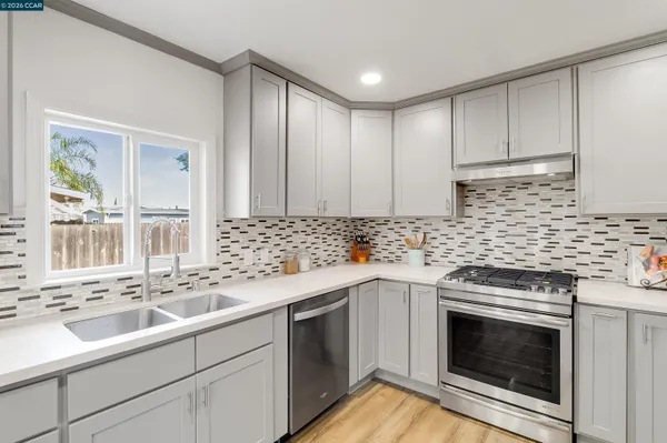 a kitchen with a sink stove and cabinets