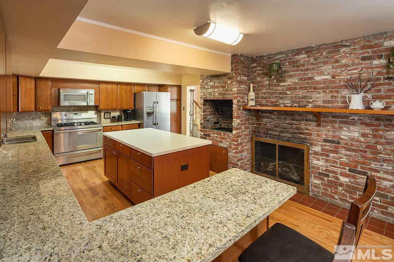 1425 Marsh Avenue Reno, NV 89509 - Photo 13 of 40 a large kitchen with cabinets table and chairs