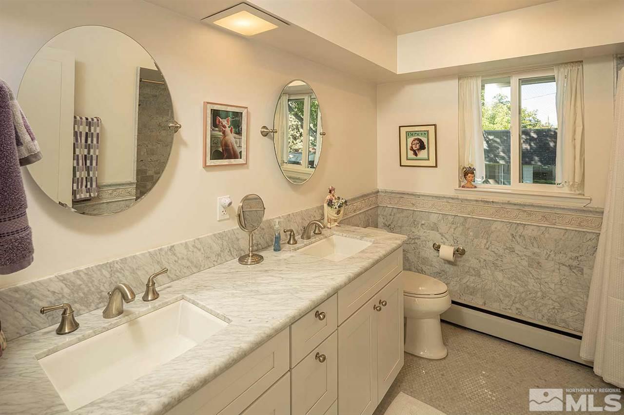1425 Marsh Avenue Reno, NV 89509 - Photo 19 of 40 a bathroom with a granite countertop sink mirror vanity and toilet