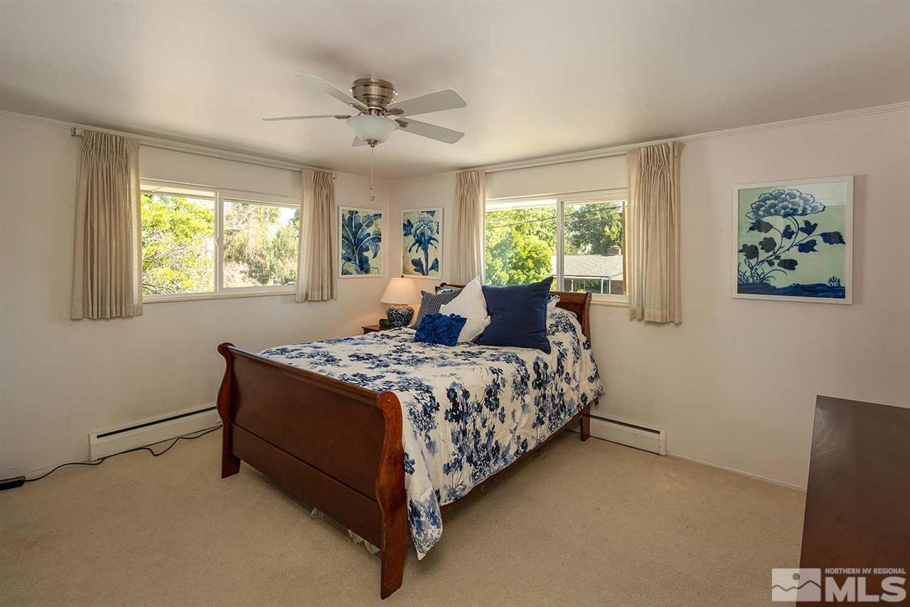 1425 Marsh Avenue Reno, NV 89509 - Photo 21 of 40 a bed sitting in a bedroom next to a window