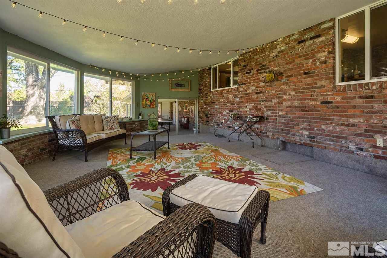 1425 Marsh Avenue Reno, NV 89509 - Photo 27 of 40 a living room with patio furniture and a fireplace