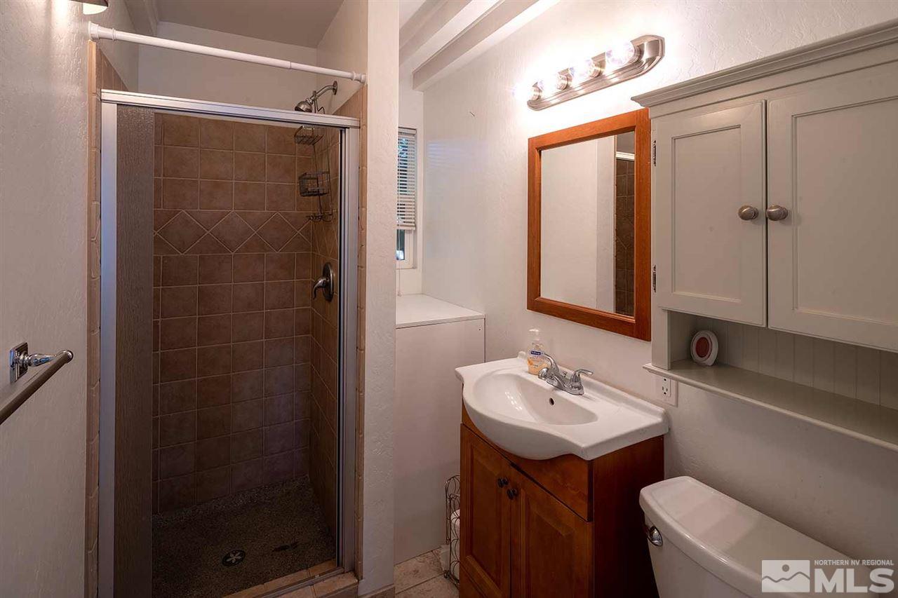 1425 Marsh Avenue Reno, NV 89509 - Photo 34 of 40 a bathroom with a sink toilet a mirror and shower