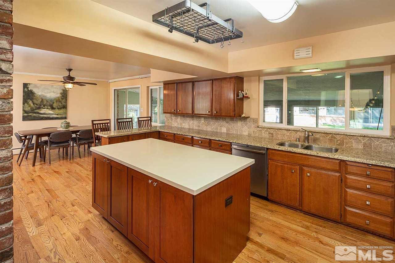 1425 Marsh Avenue Reno, NV 89509 - Photo 10 of 40 a kitchen with stainless steel appliances granite countertop a sink and a stove