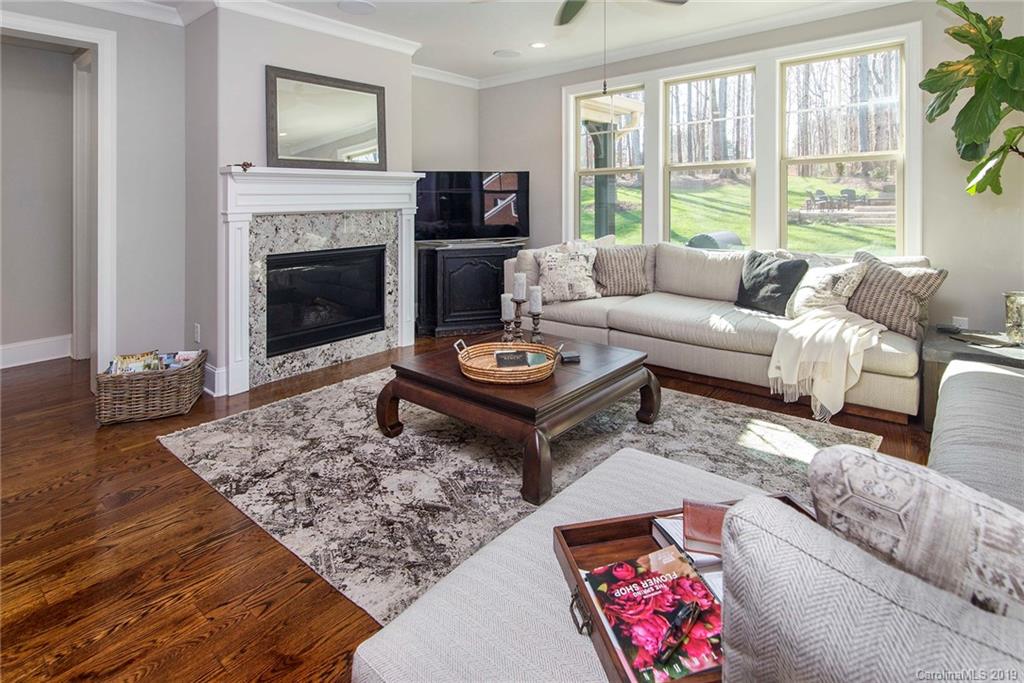 210 Patternote Road, Unit 31 Mooresville, NC 28117 - Photo 4 of 29 a living room with furniture and a fireplace