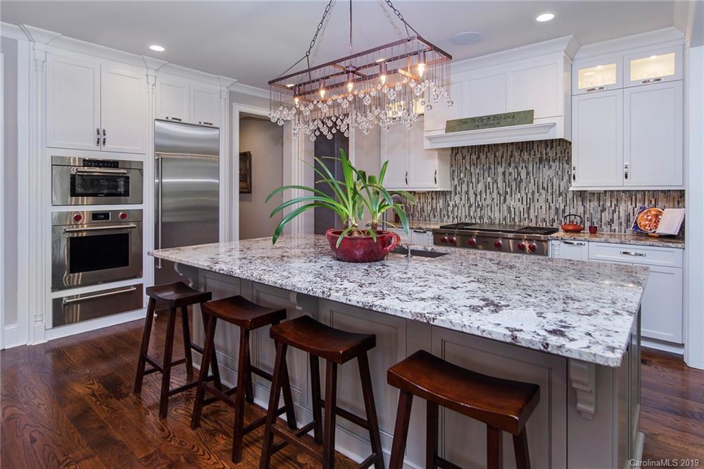 210 Patternote Road, Unit 31 Mooresville, NC 28117 - Photo 5 of 29 a kitchen with granite countertop kitchen island stainless steel appliances a sink stove and refrigerator