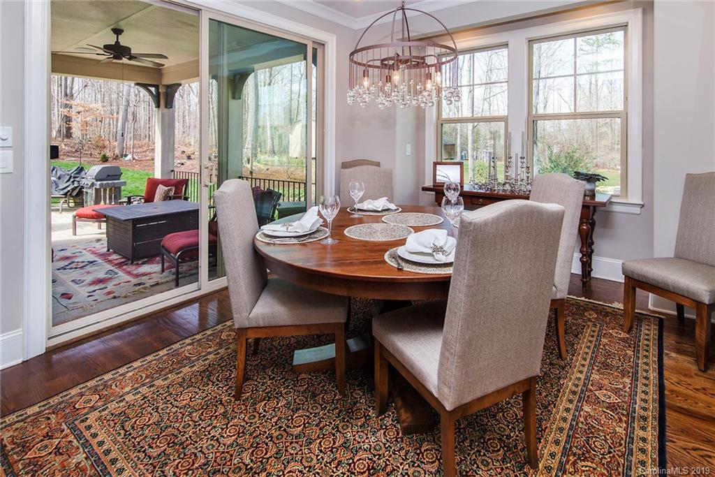 210 Patternote Road, Unit 31 Mooresville, NC 28117 - Photo 9 of 29 a dining room with furniture a chandelier and wooden floor