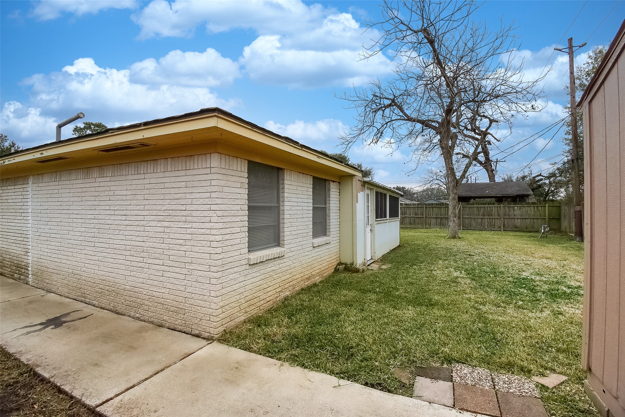 731 Dunwick Lane Pasadena, TX 77502 - Photo 45 of 46 Side Yard with Sidewalk to Shed
