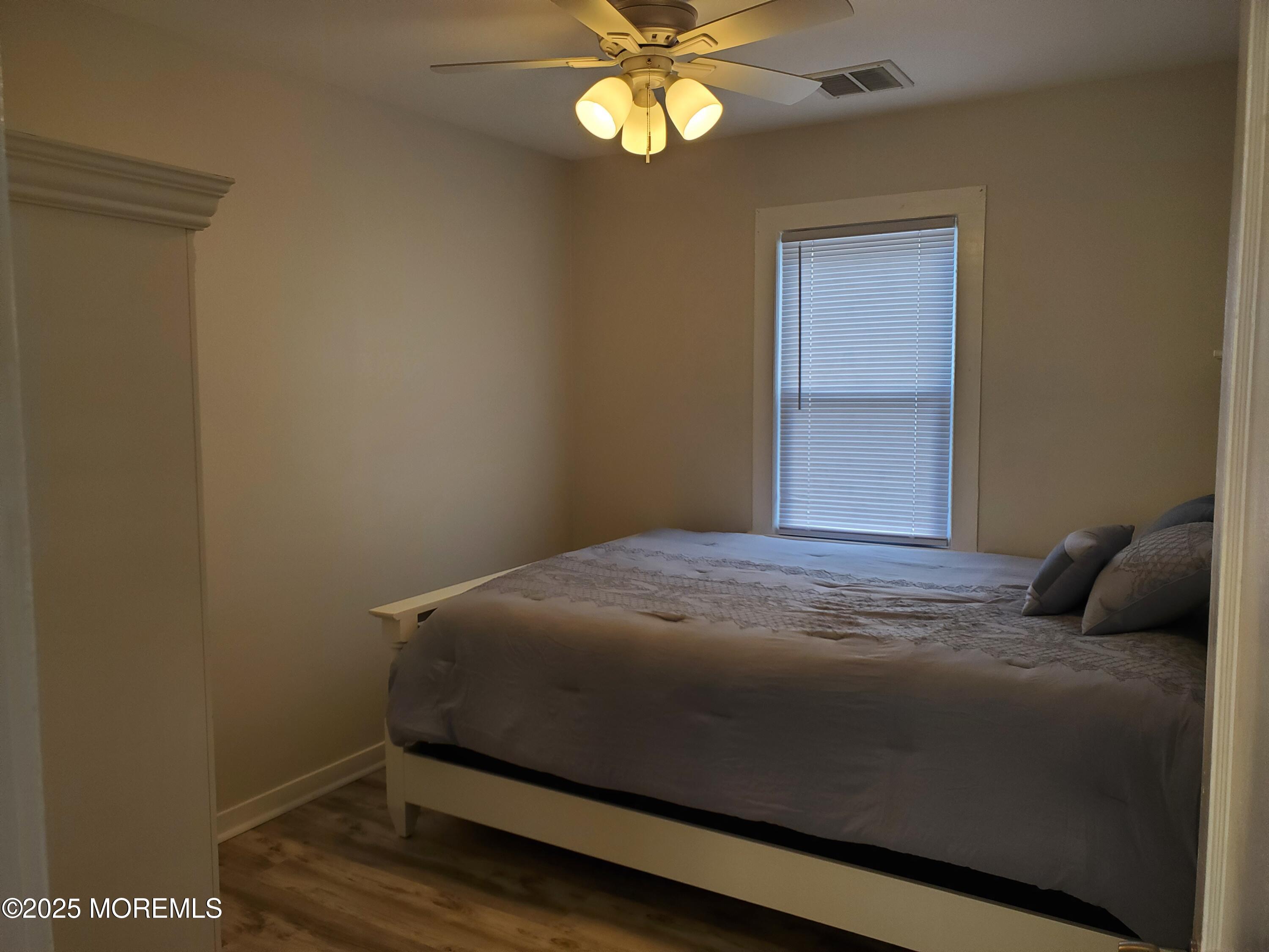 115 Dupont Avenue, Unit C Seaside Heights, NJ 08751 - Photo 6 of 6 a bedroom with a bed and a window