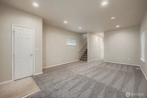 an empty room with closet and a hallway