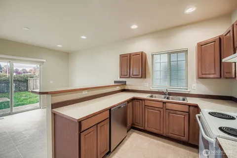 a kitchen with a sink stove and cabinets