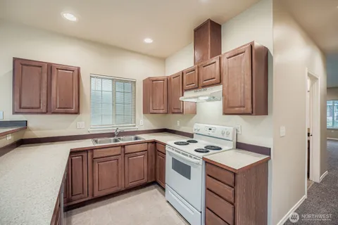 a kitchen with a sink stove and cabinets