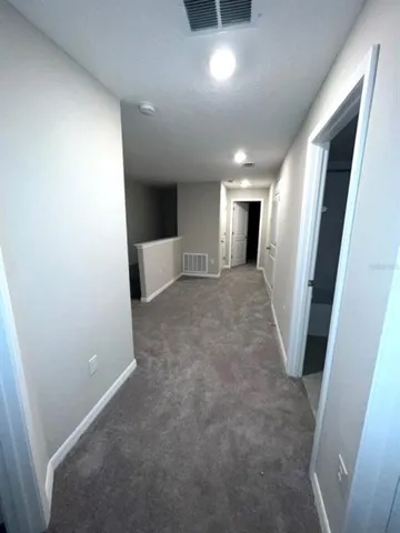 en empty room with windows and a fireplace