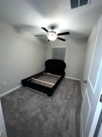 a living room with furniture and a ceiling fan
