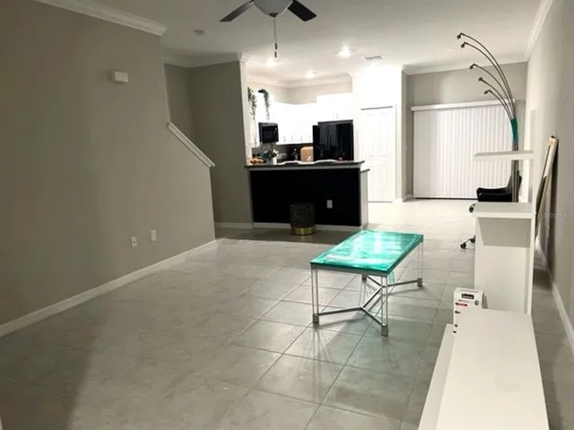 a kitchen with stainless steel appliances kitchen island granite countertop a sink and a refrigerator