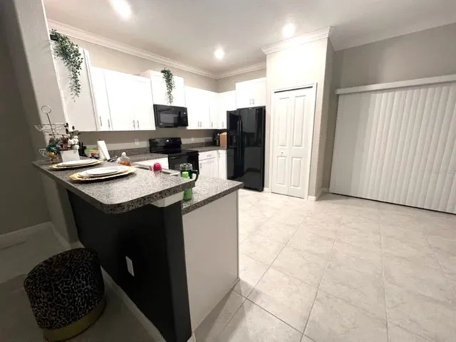 a kitchen with a sink refrigerator and microwave