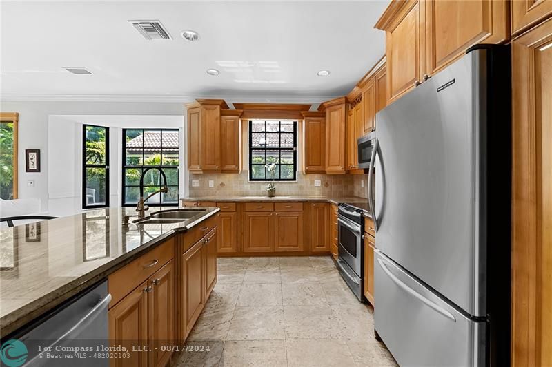 23285 Mirabella Circle Boca Raton, FL 33433 - Photo 11 of 31 a kitchen with granite countertop a refrigerator and a sink