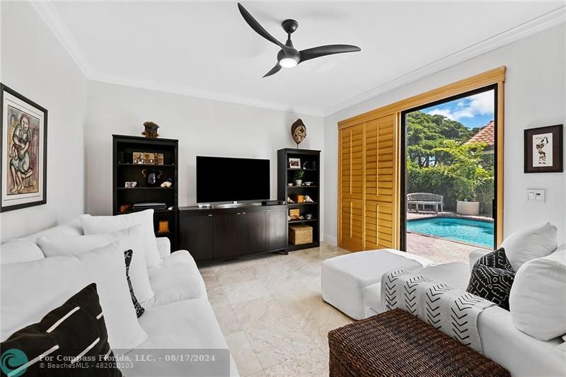 23285 Mirabella Circle Boca Raton, FL 33433 - Photo 14 of 31 a living room with furniture a ceiling fan and a flat screen tv
