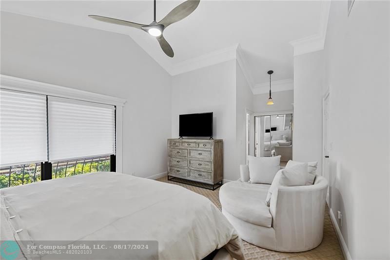 23285 Mirabella Circle Boca Raton, FL 33433 - Photo 17 of 31 a bedroom with a bed a couch and a flat screen tv