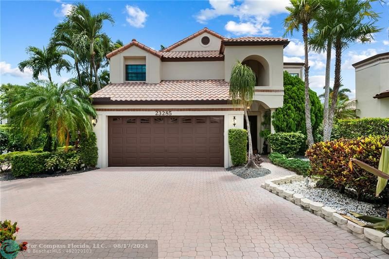 23285 Mirabella Circle Boca Raton, FL 33433 - Photo 2 of 31 a front view of a house with garden