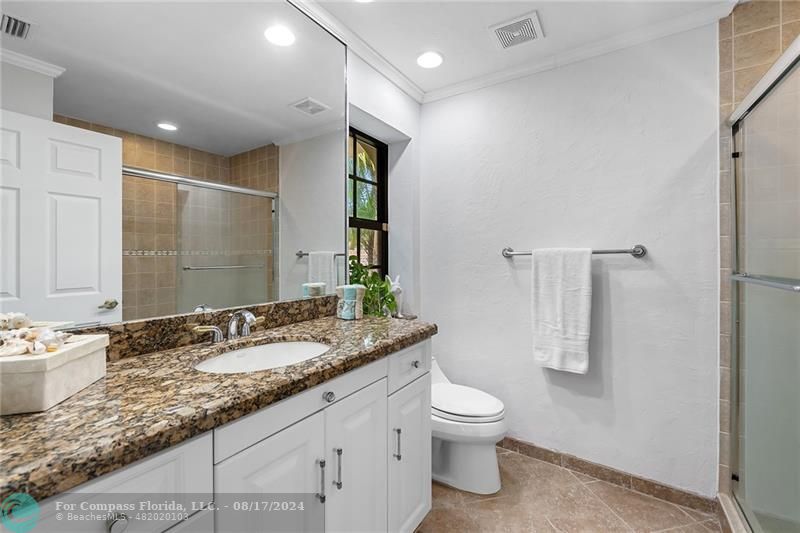 23285 Mirabella Circle Boca Raton, FL 33433 - Photo 25 of 31 a bathroom with a granite countertop sink a toilet and a large mirror