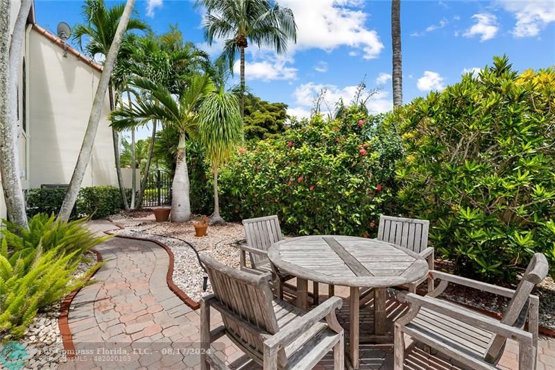 23285 Mirabella Circle Boca Raton, FL 33433 - Photo 26 of 31 a view of a patio with table and chairs and potted plants