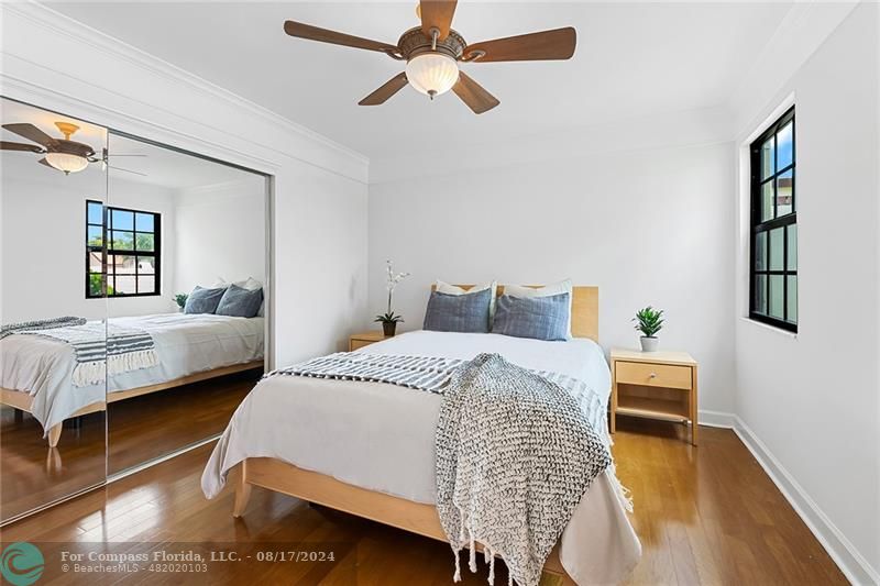 23285 Mirabella Circle Boca Raton, FL 33433 - Photo 27 of 31 a bedroom with a bed and wooden floor