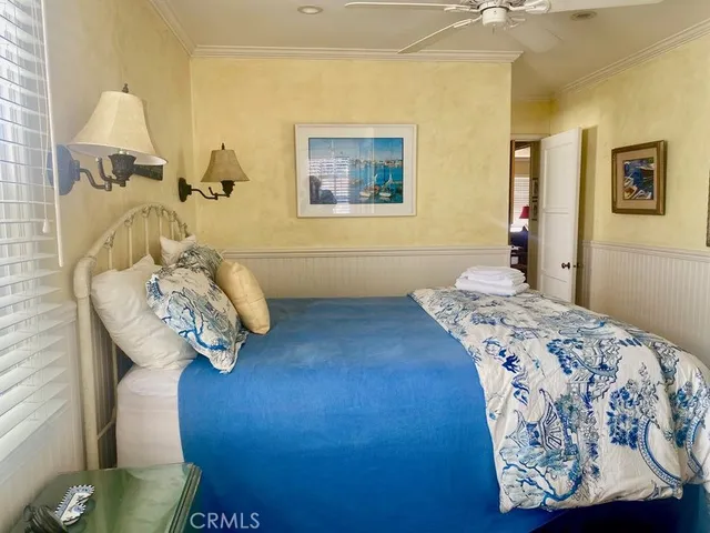 a bedroom with a bed and a wooden floor