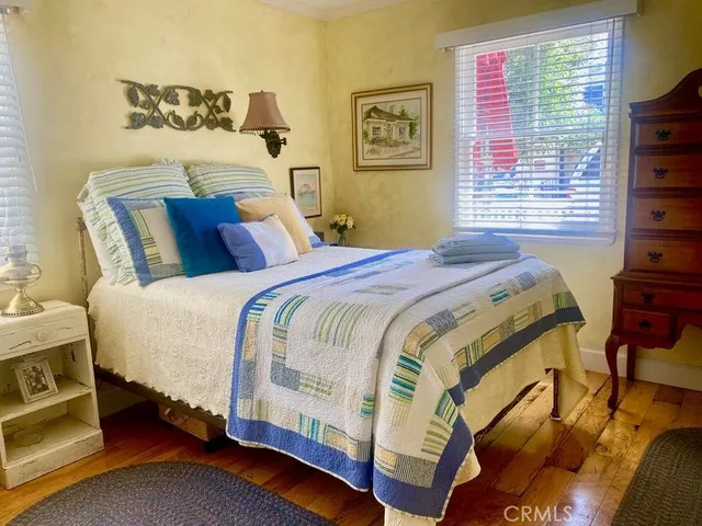 a bed sitting in a bedroom next to a window