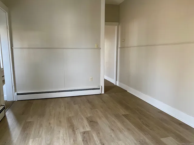 an empty room with wooden floor