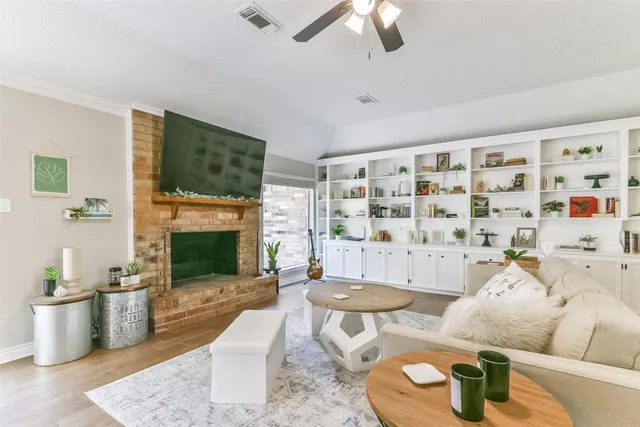 a living room with fireplace furniture and a flat screen tv