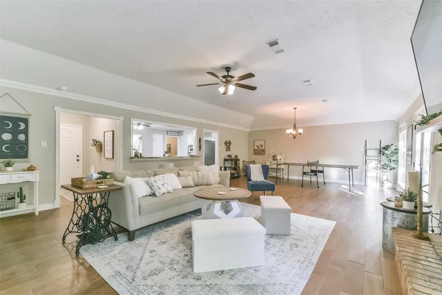 a living room with lots of furniture and a chandelier