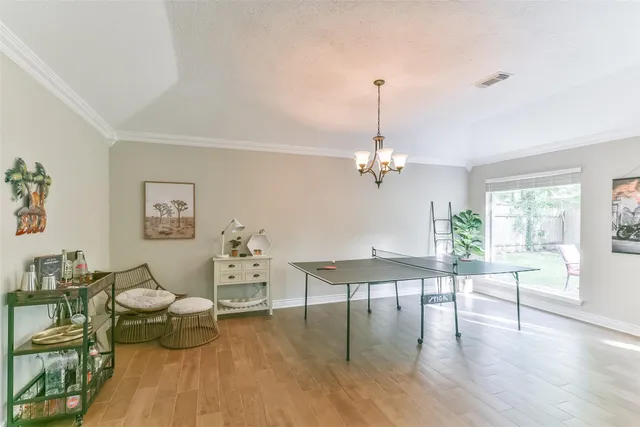 a living room with furniture dining table and a chandelier