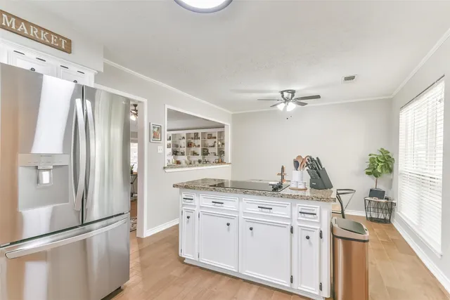 a view of kitchen with stainless steel appliances cabinets and wooden floor